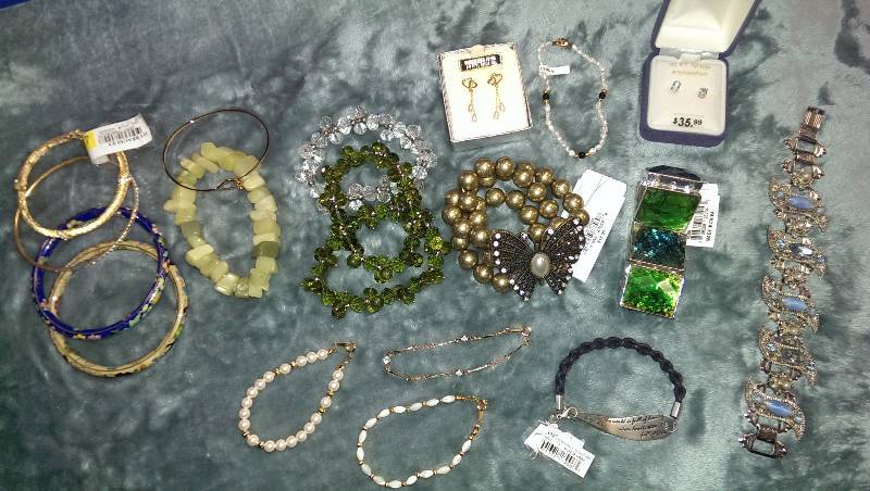 Two pairs of pierced earrings (10k and 14k gold, and aquamarine), and a variety of bracelets.