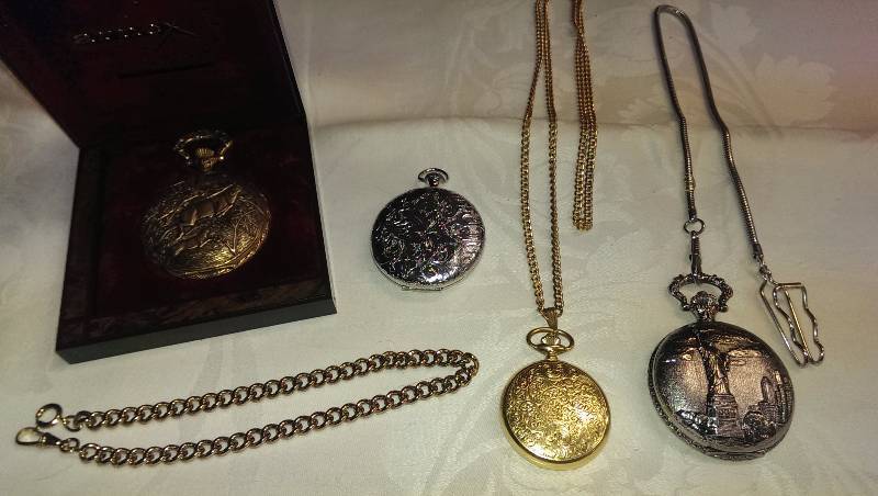 Four pocket watches and chains.