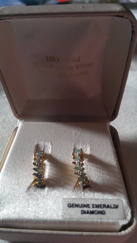 Pierced earrings (18k gold with diamond and emerald accents).