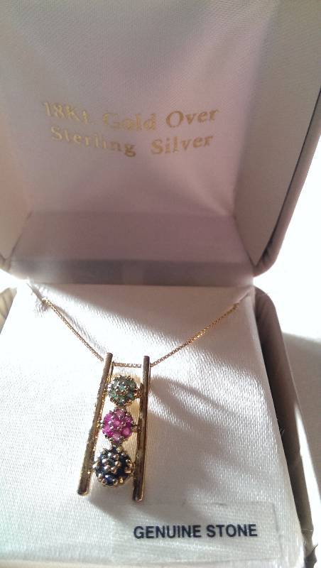 Necklace (18k gold with diamond,emerald, garnet and sapphire accents).