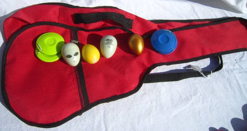 lot 658 image: (4) Egg Shakers, (2) Castanets, (1) small toy guitar case.