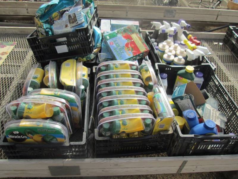 Crates of Miracle Grow and Insecticides