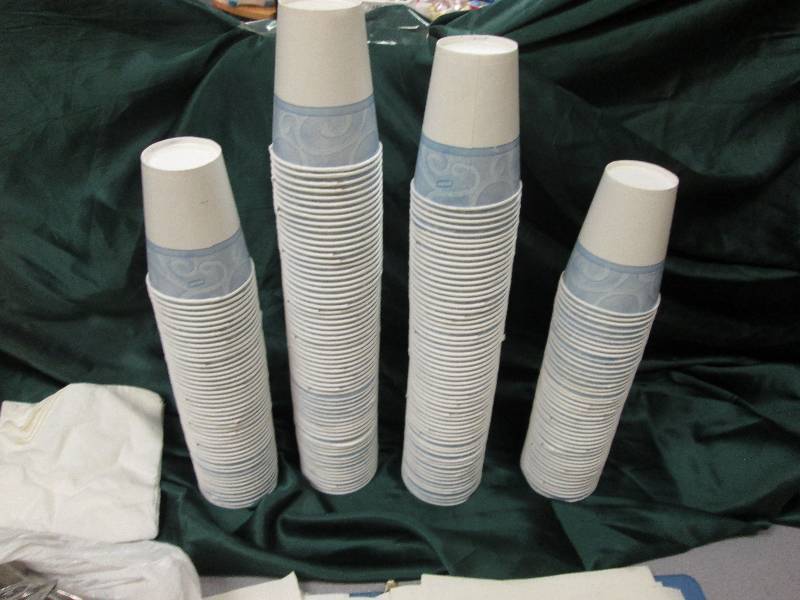 paper cups, forks, spoons, and towe...
