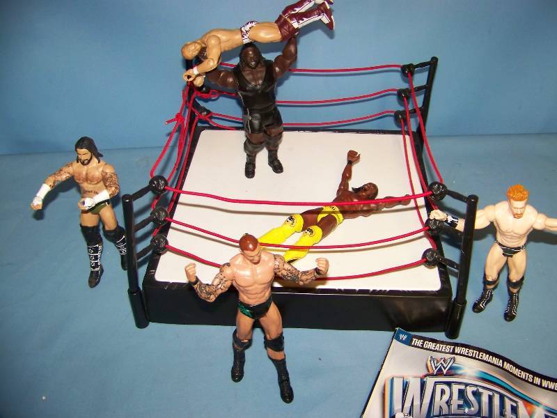 lot 10 image: WWE  WWF  WWW  WCW Wrestling Action Figures, Wrestling Ring and WrestleMania XXVIII Magazine