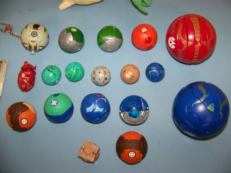 lot 15 image: Bakugan Figures and Card and a plushsoft Pokemon Ball  Character