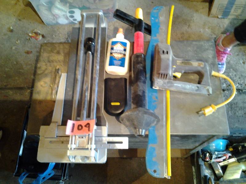 lot 104 image: Tile Cutter, Electric Stapler, Plunger, Stanley Distance Finder