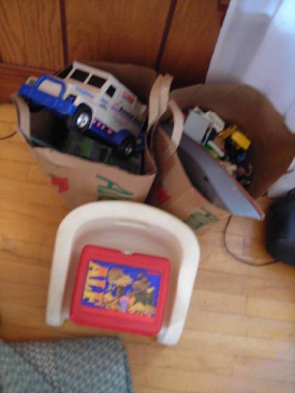 lot 203 image: Booster Seat, Crayons, 2-Bags Of Toys