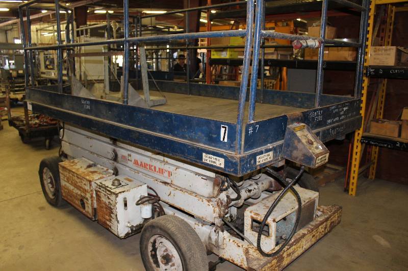 lot 21 image: Mark Lift Scissors Lift wGated Platform 1408.2 Hours Indicated Model MX20 Needs Battery & Tires Works.