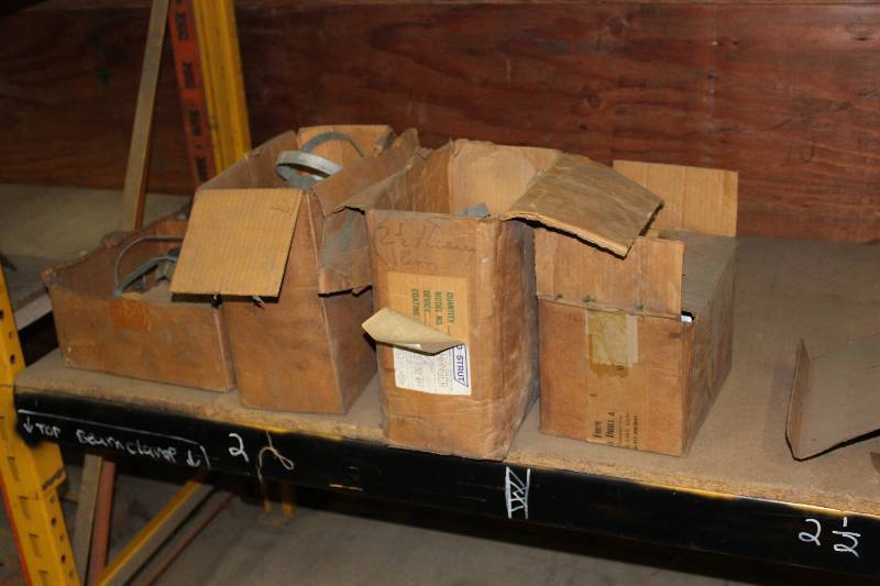 lot 560 image: Shelf Lot Including Miscellaneous Clevis Metal Hangers And More.