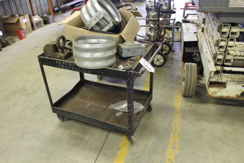 lot 564 image: Push Cart wLower Shelf & Wheels Includes Contents Corrugated Metal Fittings And More.