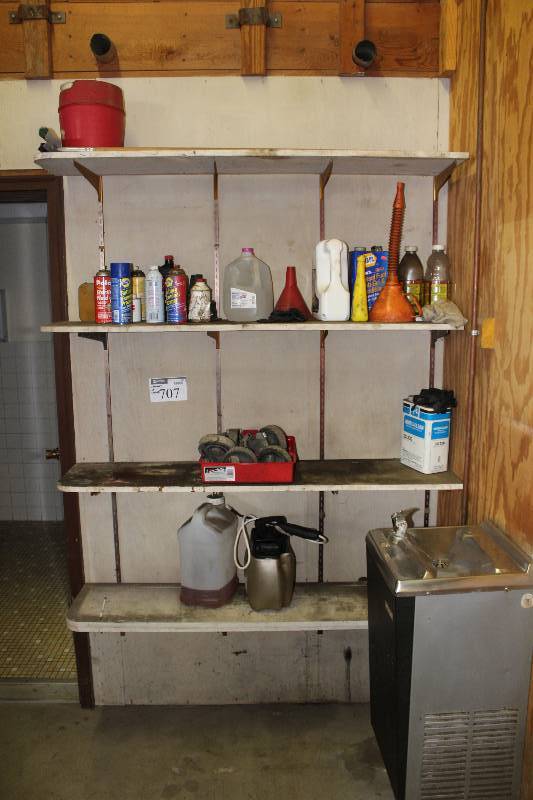 lot 707 image: Contents of Shelves Including Bucket of Fluids Funnel wHose NAPA Battery Terminal Protectant And More.