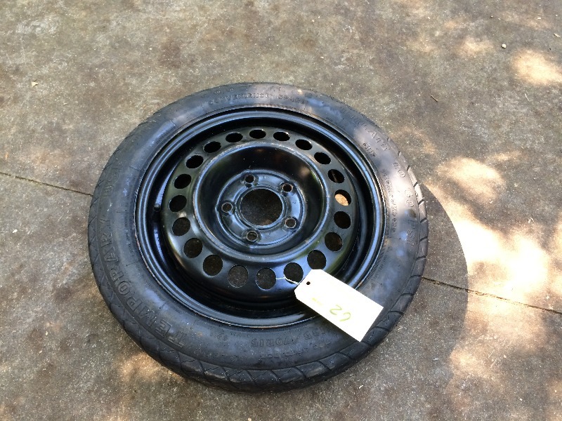 lot 27 image: Pontiac  5 bolt donut spare tire  Like new