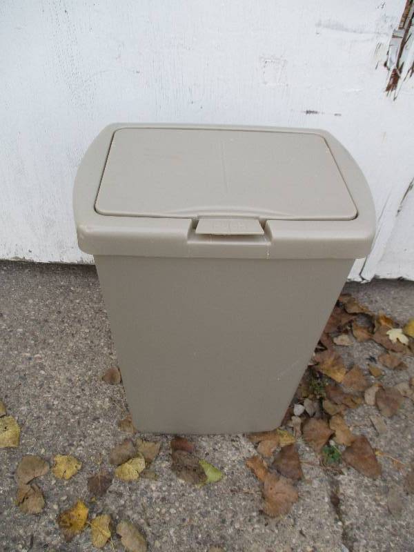 Plastic trash can with pop-up lid...