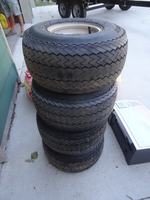 4 trailer tires with rims.
