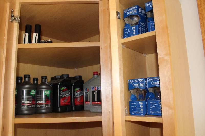 lot 232 image: Contents of Cupboard Including Synthetic Oil Quarts Crystal Clear Light Bulbs.