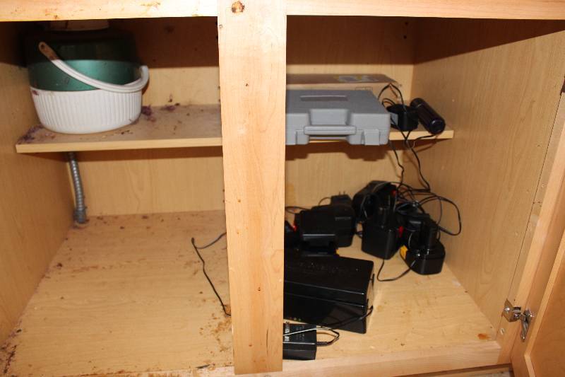 lot 235 image: Contents of Cupboard Including Thermos Plastic Case Chargers And More.