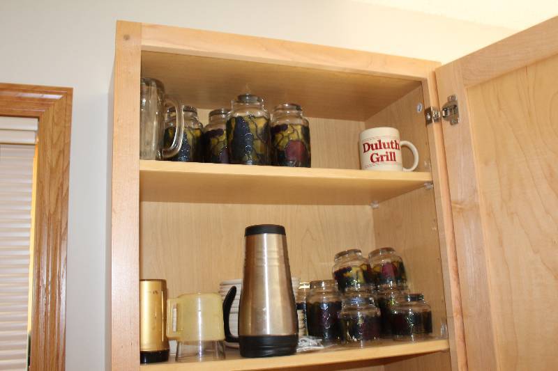 lot 231 image: Contents of Cupboard Including Drinking Glasses Coffee Cups Plates And More.