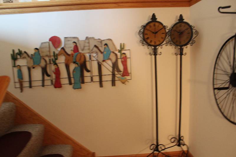 lot 245 image: Stairway Lot of Wall Decorations Including Standing Clocks Old-School Bicycle And More.