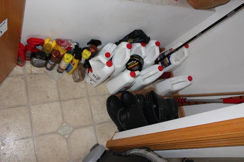lot 456 image: Bottom Half Of The Closet Including Cleaners Boots Septic Tank Cleaner And More.