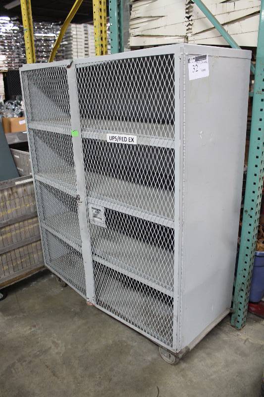 lot 32 image: Shelving Unit wMetal Grate Double Doors & Wheels 23 x 53 x 68.5.