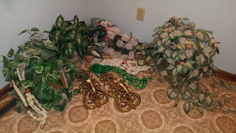 Fake plants with hangers and a pair of wall sconces