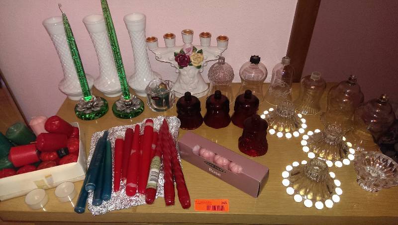 Variety of candlebras, glass candle flutes, and candles