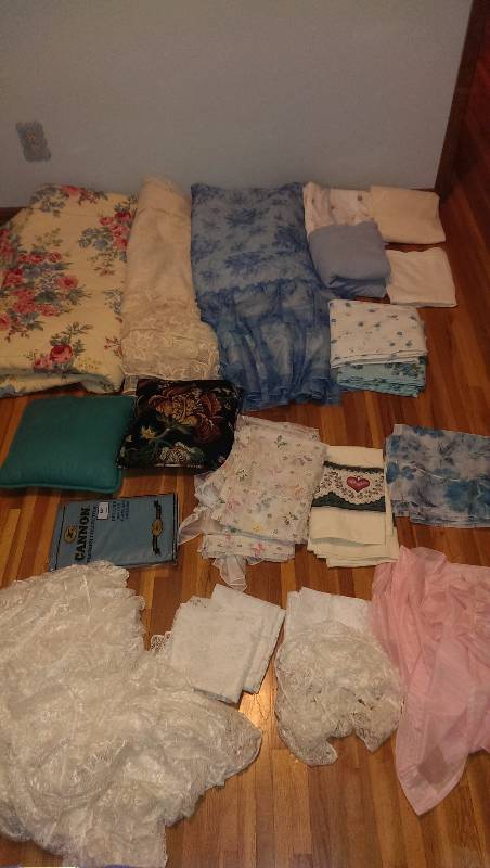 Three full size bedspreads, sheets (full and twin), variety of curtain panels, table cover, throw pillows