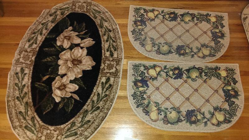 Three rugs, two matching and one brown floral oval
