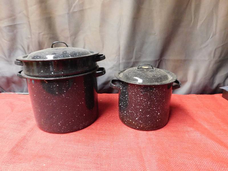 two black enamelware double boilers one large one medium two lids
