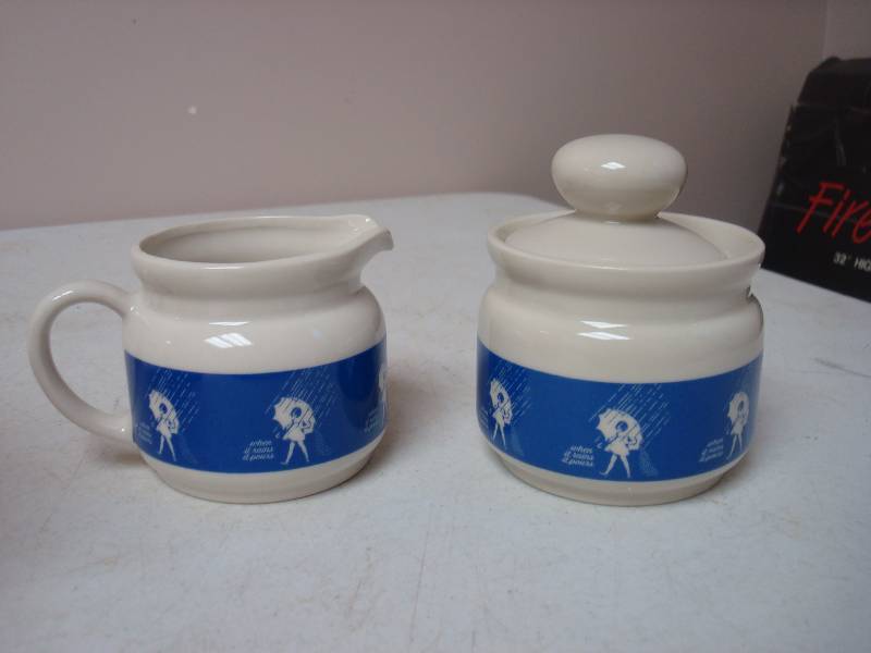 lot 36 image: Pair Of When It Rains, It Pours Creamers