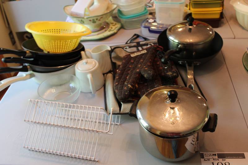 Table Lot Including Metal Pots Metal Frying Pan Oven Mitts And More.