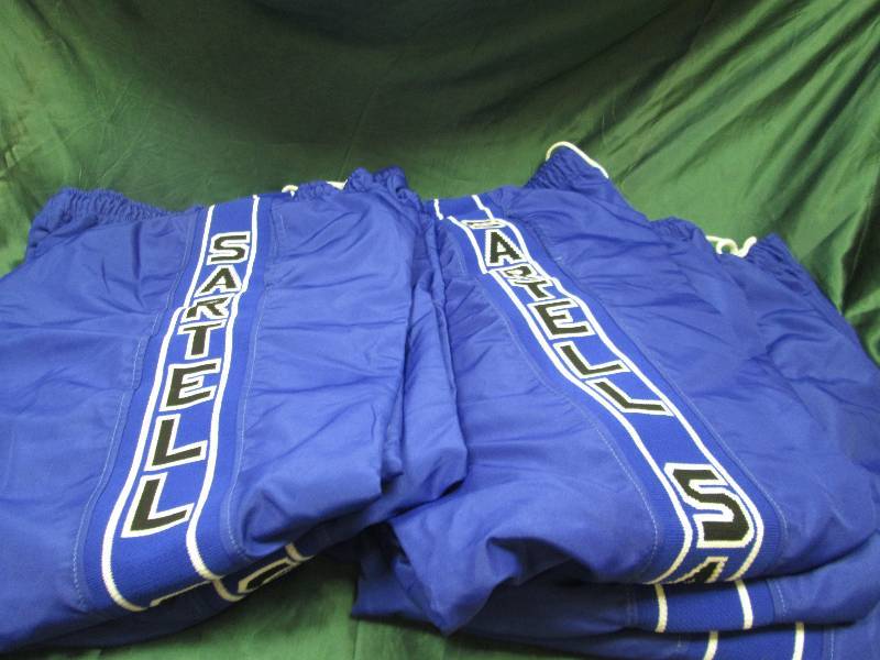 Qty 5  Blue pants that says Sartell...