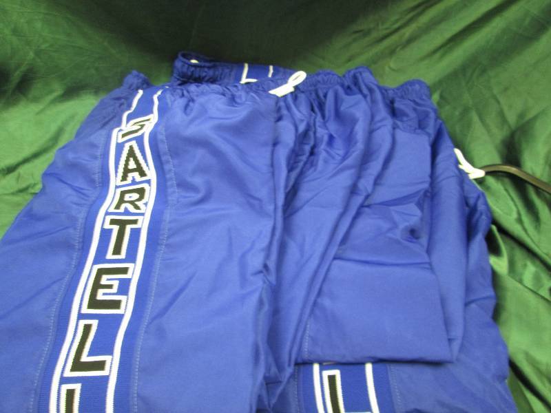 Qty 5  Blue pants that says Sartell...