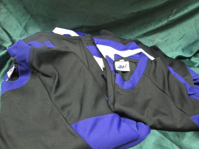 Qty 9  Black and purple jerseys siz...