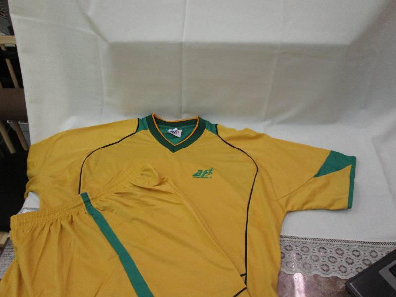 gold and green shirts with black pi...