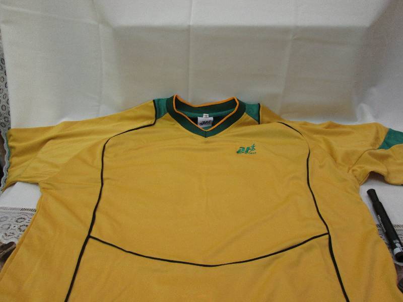Gold shirts with green and black ac...