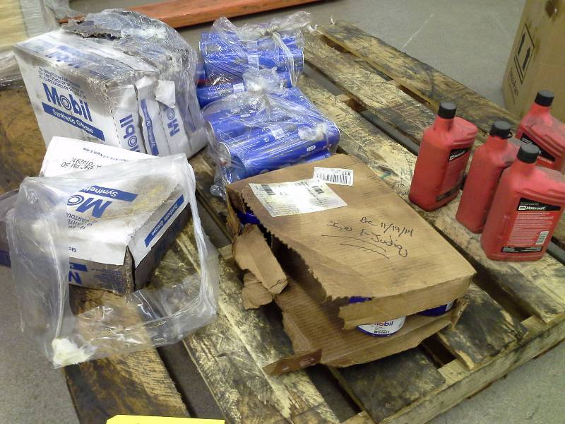 lot 158 image: As-Is lot of ruptured grease cases, misc. Mobil filters and other fluids. Several are still good, but will have exposed grease on their outer hulls.