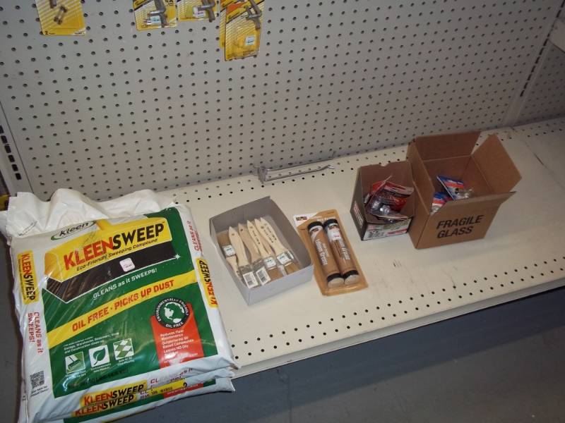lot 173 image: Shelf Lot includes Sweeping Compound, Small Brushes, Grease, Spark Plugs, Auto Light Bulbs