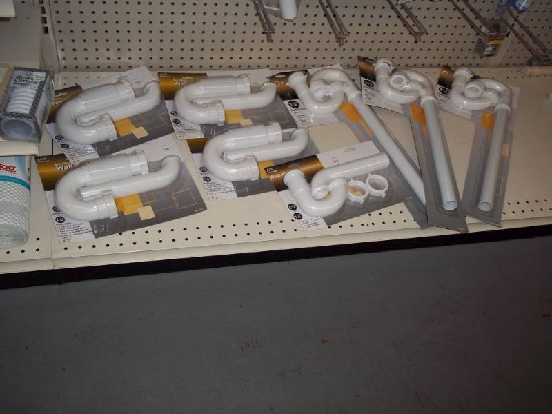lot 196 image: 4 ft Shelf lot includes Plastic Bathroom Drain Pipes