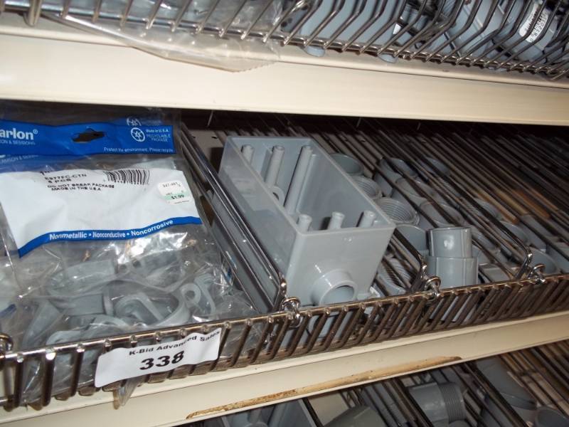 lot 338 image: 4 ft Shelf of Conduit parts, Electrical parts, electrical plates, outdoor Switches