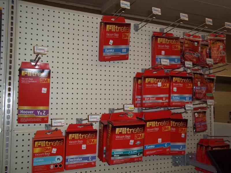 lot 580 image: Wall Shelf includes Variety of vacuum cleaner Bags and belts