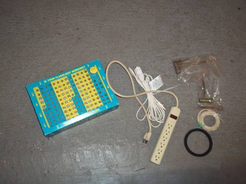 lot 876 image: Lash light Repair Bulb Kit, Used Extension Cord, Used Plug In Bar, and Chain Saw Wrenches