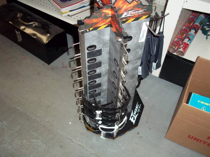 lot 877 image: Sunglass Display with New Sunglasses and Cases