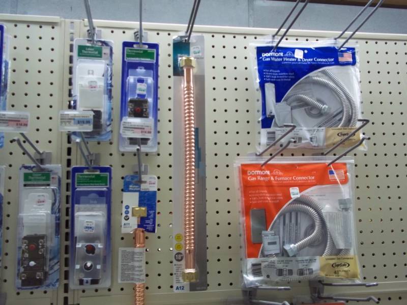 lot 1038 image: Wall Lot including Hot Water Heater Thermostats, Range Gas Connectors, etc