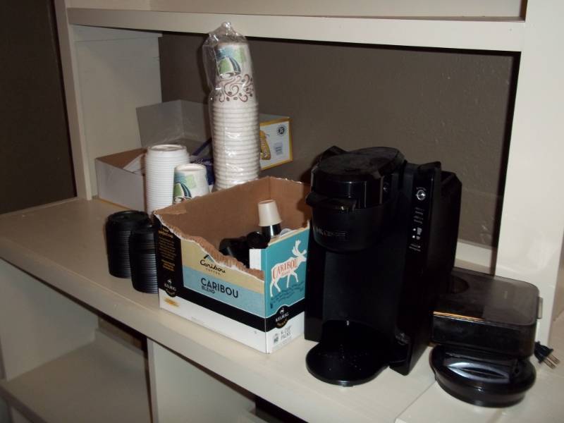 lot 1202 image: Used Coffee maker with creamer cups and spoons