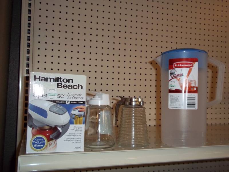 lot 1239 image: Shelf lot with can opener, syrup jars and pitcher