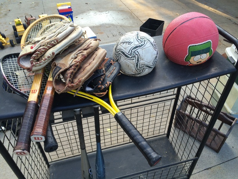 lot 84 image: Sporting Storage Rack - great for bats,  balls, and accessories - includes all the contents in the pictures