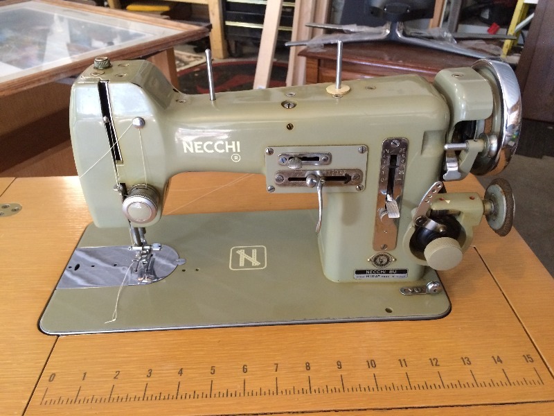 lot 123 image: Vintage sewing machine and cabinet