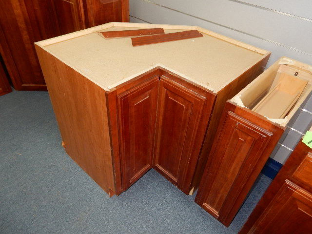Walnut wood LOWER Cabinets. 4 Sections. .Sink, Drawer, Corner unit with lazy Susan, Pull out storage cabinet.   Matches cabinets in lots 11, 13, 14.