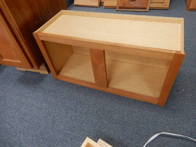 Upper cabinet with no doors, 1 lower cabinet with drawer and cabinet.